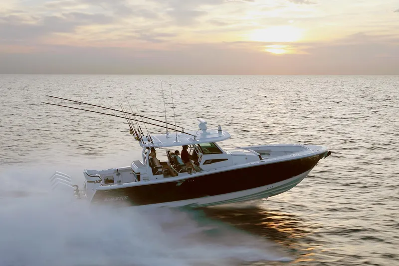 Slide: The Image of 2025 Blackfin 400 CC boat cruising at sunset on open water. - 2