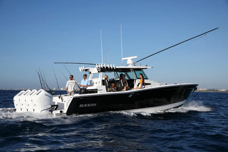 Slide: The Image of 2025 Blackfin 400 CC boat cruising on open water with passengers onboard. - 4