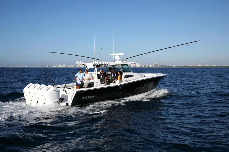 Slide: The Image of 2025 Blackfin 400 CC boat cruising on open water with passengers onboard. - 5