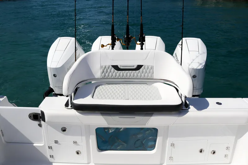 Slide: The Image of 2025 Blackfin 400 CC boat with triple engines and fishing rods on blue water. - 8