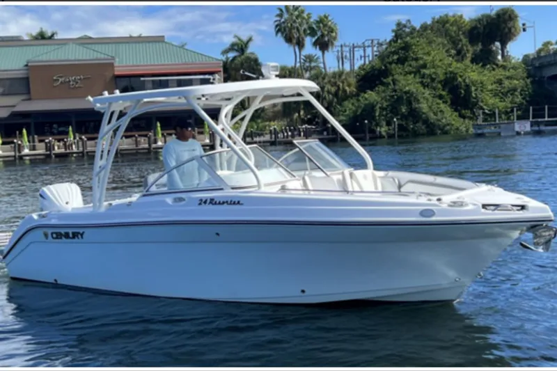 Slide: The Image of 2024 Century Resorter boat on water near a waterfront building. - 1