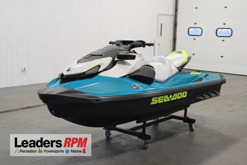 The Image of 2025 Sea-Doo GTI SE 130 jet ski in showroom, blue and white design. - 1