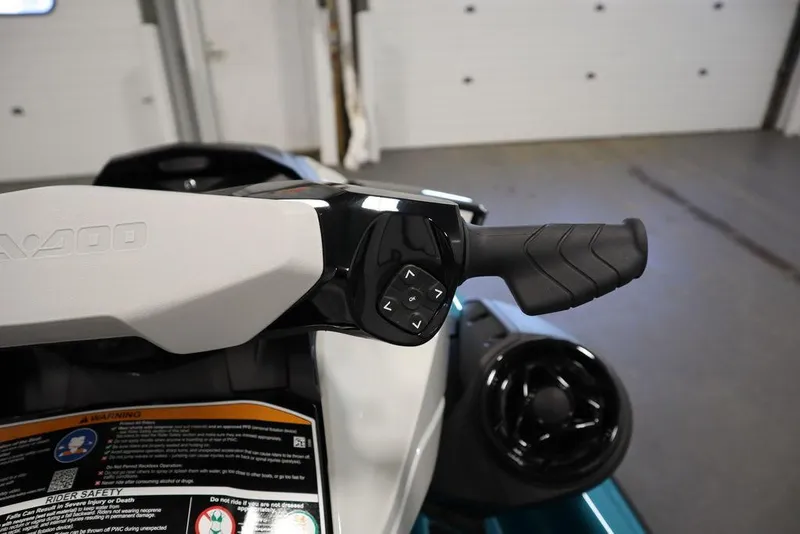 Slide: The Image of 2025 Sea-Doo GTI SE 130 handlebar with control buttons in a garage setting. - 14
