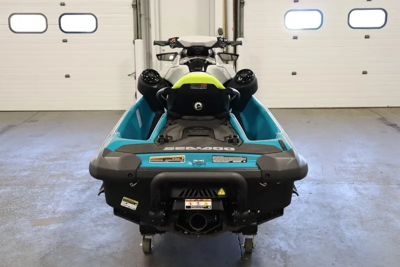 Slide: The Image of 2025 Sea-Doo GTI SE 130 jet ski in a showroom, featuring sleek blue and white design. - 5