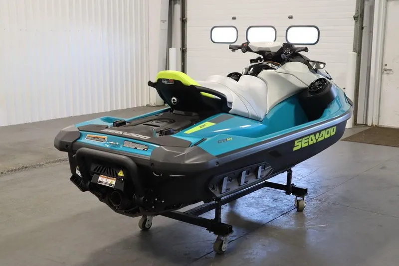 Slide: The Image of 2025 Sea-Doo GTI SE 130 jet ski in a garage, showcasing sleek design and vibrant colors. - 6