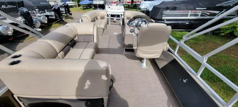 Slide: The Image of 2020 Sun Tracker 22 SPORT FISH XP3 pontoon boat interior with beige seating and steering console. - 5