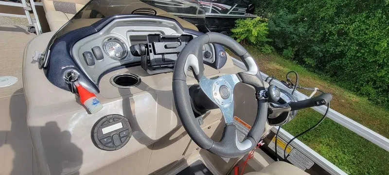 Slide: The Image of 2020 Sun Tracker 22 SPORT FISH XP3 boat dashboard with steering wheel and controls. - 6