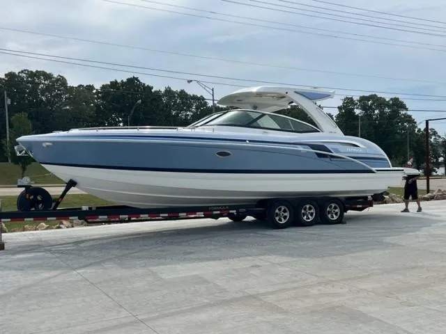 Slide: The Image of 2023 Formula 350 CBR boat on trailer, sleek design, blue and white exterior. - 2