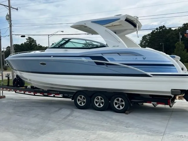 Slide: The Image of 2023 Formula 350 CBR boat on trailer, sleek design, blue and white color scheme. - 3