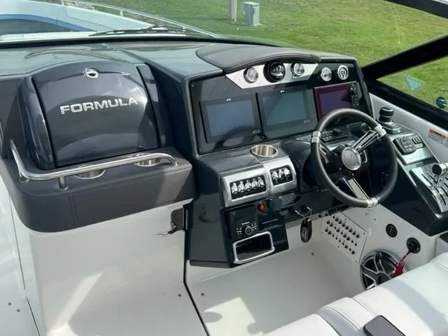 Slide: The Image of 2023 Formula 350 CBR boat cockpit with modern controls and steering wheel. - 7