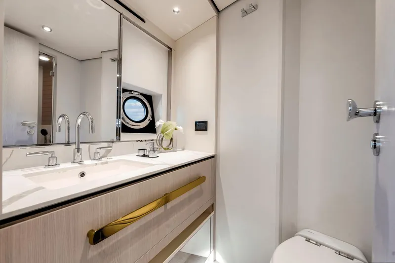 Slide: The Image of Luxurious bathroom in 2024 Azimut Fly 78 yacht with modern fixtures and porthole window. - 15