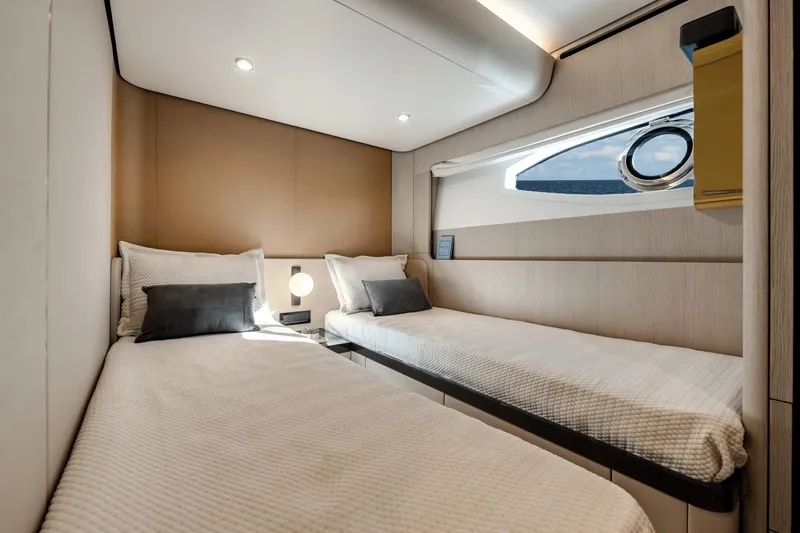 Slide: The Image of Luxurious twin bedroom on the 2024 Azimut Fly 78 yacht with modern decor. - 17