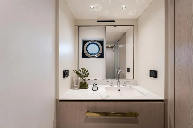 Slide: The Image of Modern bathroom on the 2024 Azimut Fly 78 yacht with sleek fixtures and porthole window. - 21