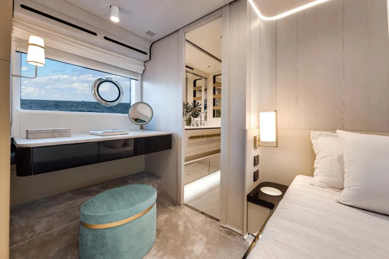 Slide: The Image of Luxurious interior of 2024 Azimut Fly 78 yacht with ocean view, vanity, and ensuite bathroom. - 25