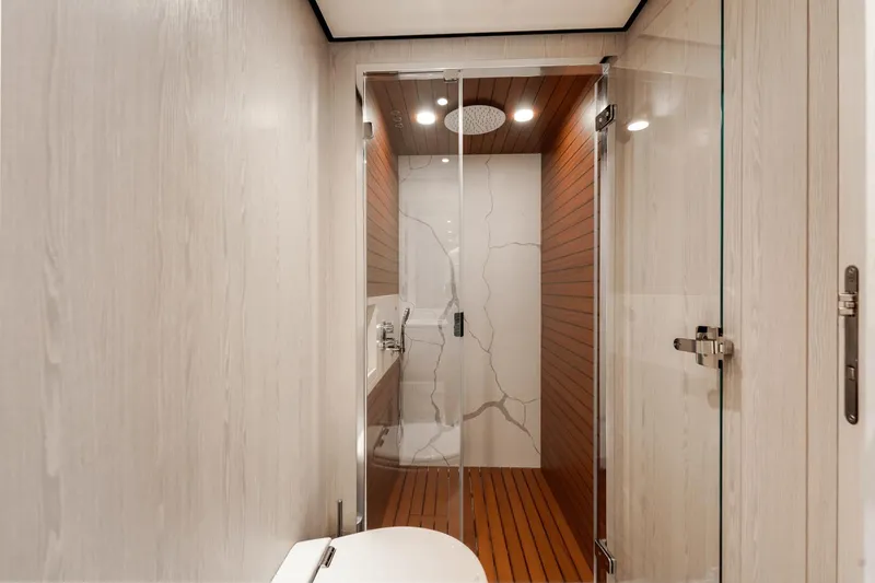 Slide: The Image of Modern shower area in 2024 Azimut Fly 78 yacht with glass doors and wooden accents. - 30