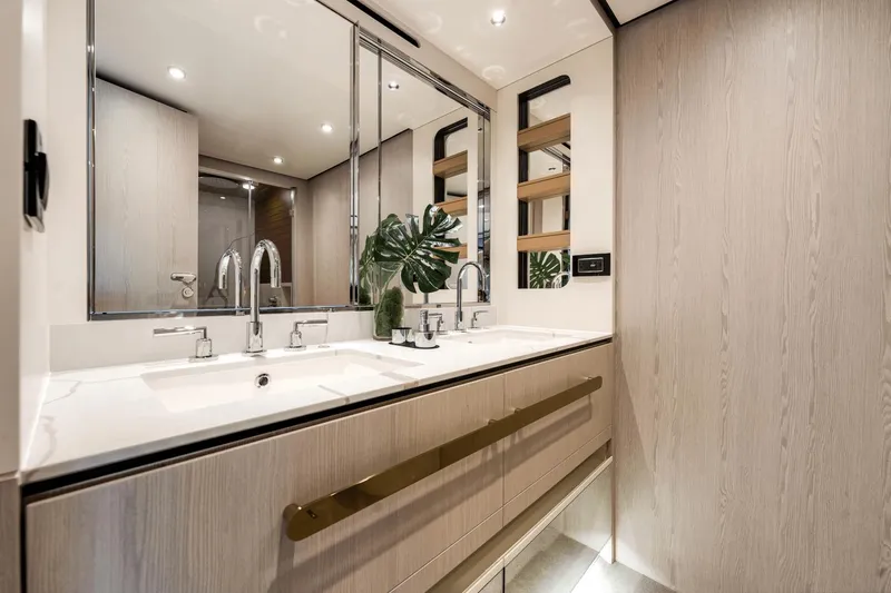Slide: The Image of Luxurious bathroom in the 2024 Azimut Fly 78 yacht with double sinks and modern fixtures. - 31