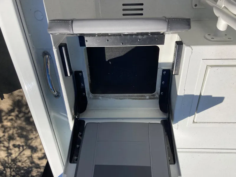Slide: The Image of 2022 Lowe BAY 20 boat storage compartment with padded seat. - 12
