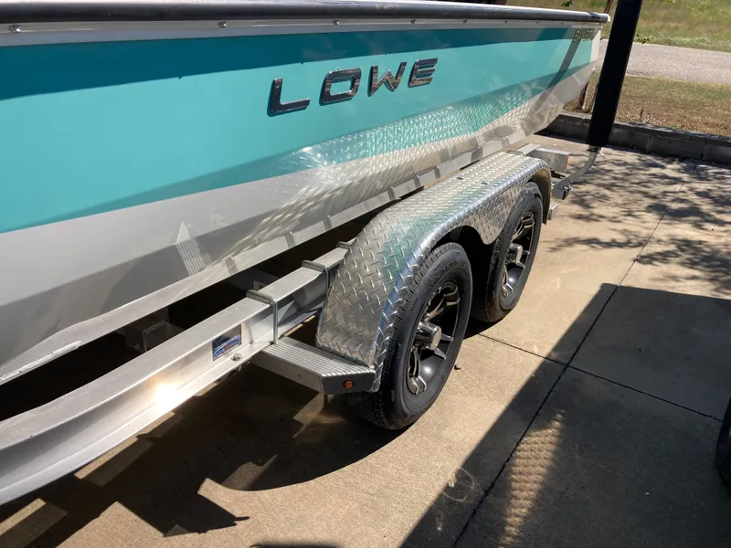 Slide: The Image of 2022 Lowe BAY 20 boat on a trailer, side view. - 15