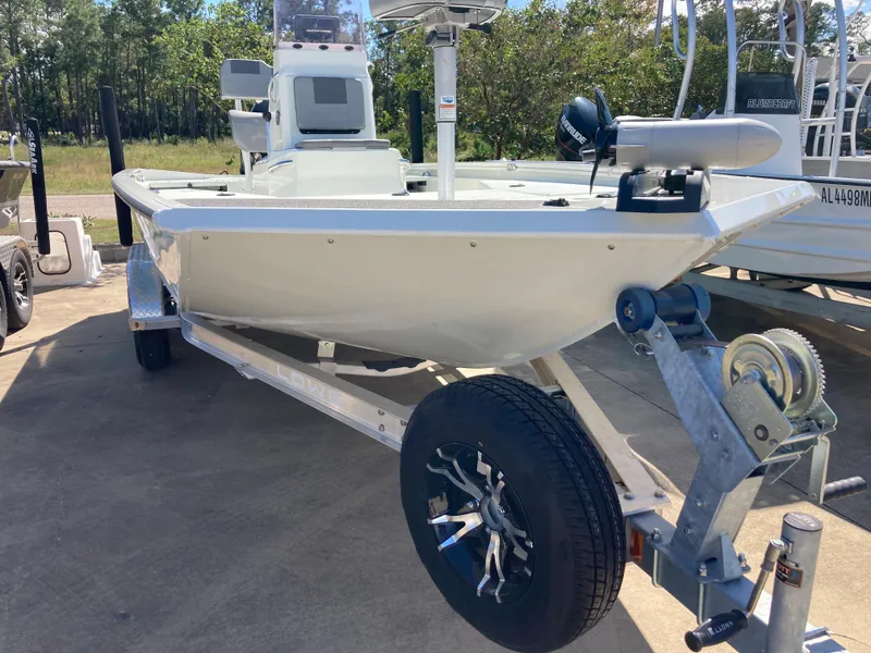 Slide: The Image of 2022 Lowe BAY 20 boat on a trailer in a marina. - 16