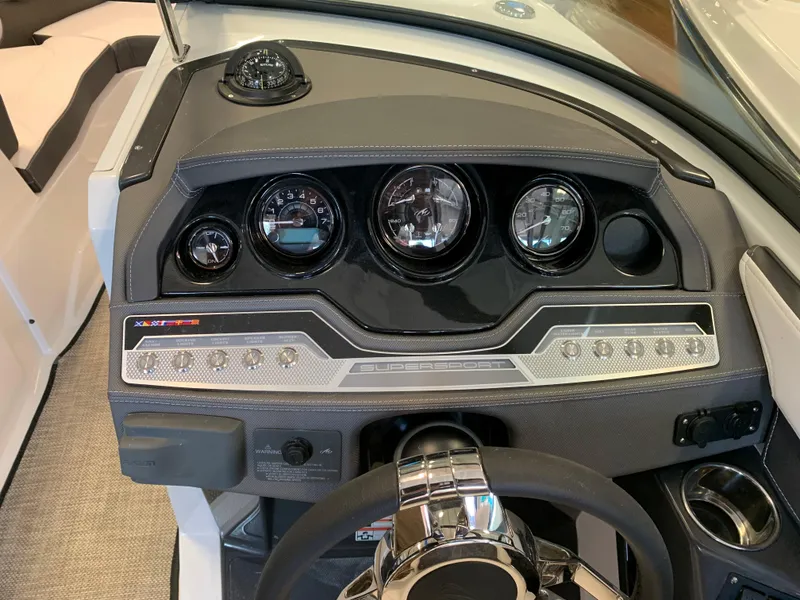 Slide: The Image of 2024 Monterey 258 Super Sport boat dashboard with gauges and steering wheel. - 6