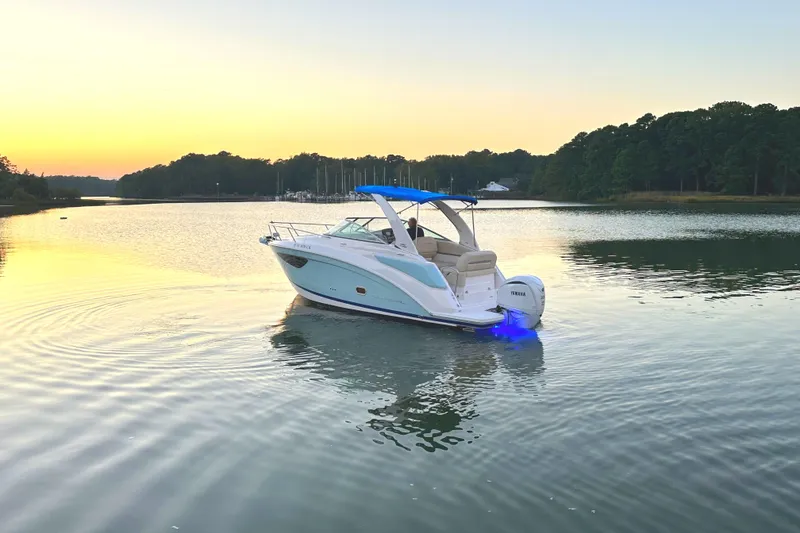 Slide: The Image of 2022 Regal 26XO boat on calm lake at sunset. - 1
