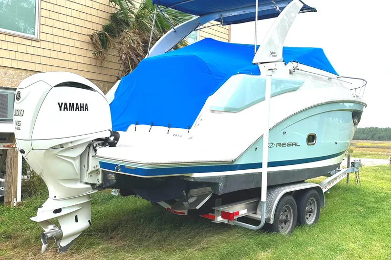 Slide: The Image of 2022 Regal 26XO boat with Yamaha outboard engine on a trailer. - 11