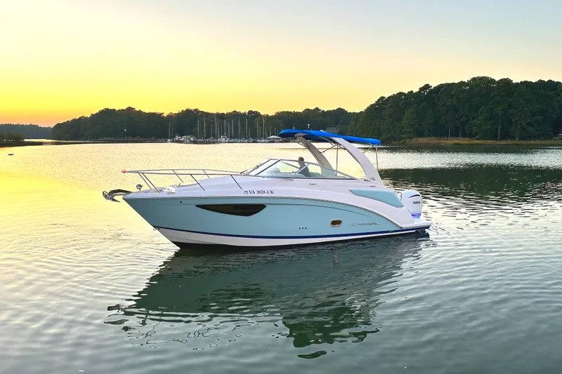 Slide: The Image of 2022 Regal 26XO boat on calm water at sunset. - 23