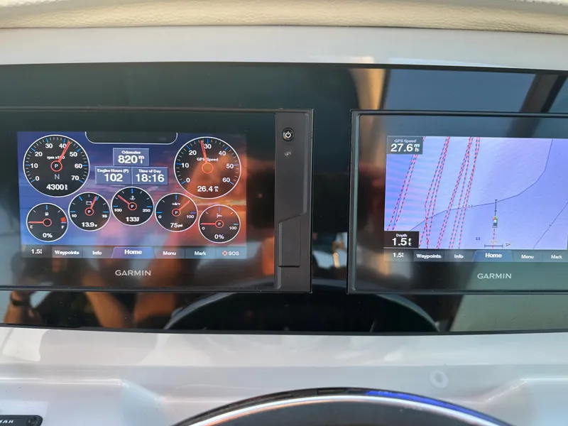 Slide: The Image of Garmin navigation and control screens on a 2022 Regal 26XO boat. - 28