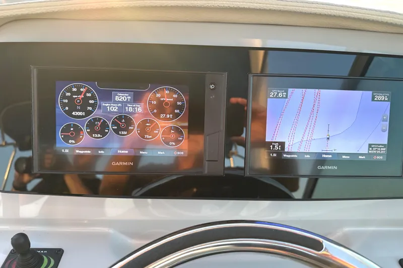 Slide: The Image of Garmin navigation and control screens on a 2022 Regal 26XO boat dashboard. - 31