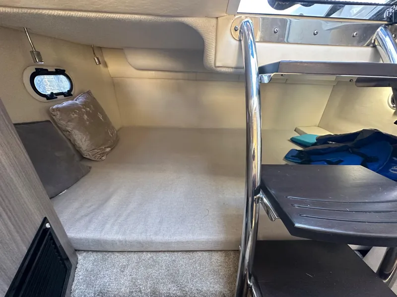 Slide: The Image of 2022 Regal 26XO cabin interior with bed and ladder. - 32