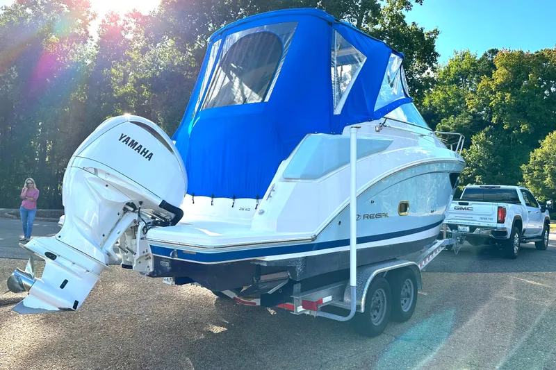 Slide: The Image of 2022 Regal 26XO boat with Yamaha engine on trailer, blue canopy, sunny day. - 4