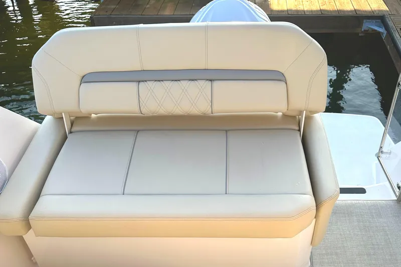Slide: The Image of 2022 Regal 26XO boat with beige cushioned seating at the stern. - 41