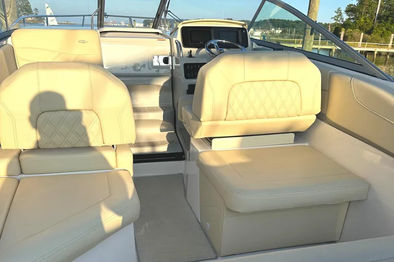 Slide: The Image of 2022 Regal 26XO boat interior with beige leather seating and modern dashboard. - 42