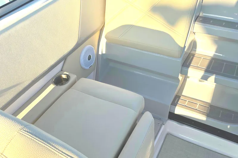 Slide: The Image of Interior seating of 2022 Regal 26XO boat with cup holder and speaker. - 44
