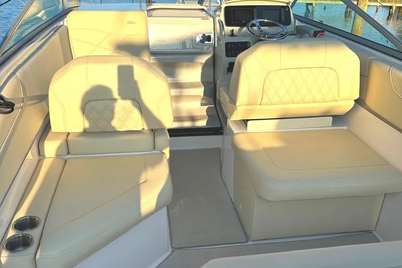 Slide: The Image of 2022 Regal 26XO boat interior with beige seating and steering console. - 45