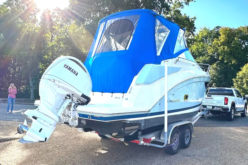 Slide: The Image of 2022 Regal 26XO boat with blue canopy and Yamaha outboard motor on trailer. - 46