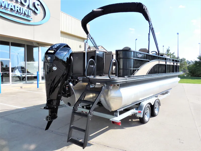 Slide: The Image of 2024 Bennington 23 SXF-APG pontoon boat on a trailer outside a marine dealership. - 3