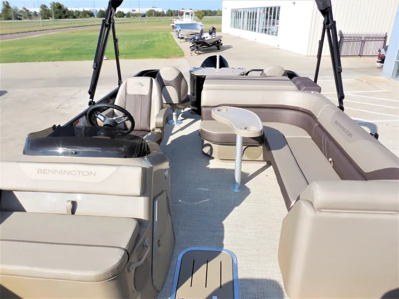 Slide: The Image of 2024 Bennington 23 SXF-APG pontoon boat interior with spacious seating and helm. - 5
