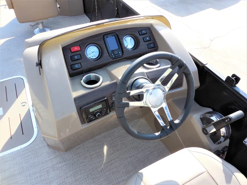 Slide: The Image of 2024 Bennington 23 SXF-APG boat dashboard with steering wheel and instrument panel. - 6