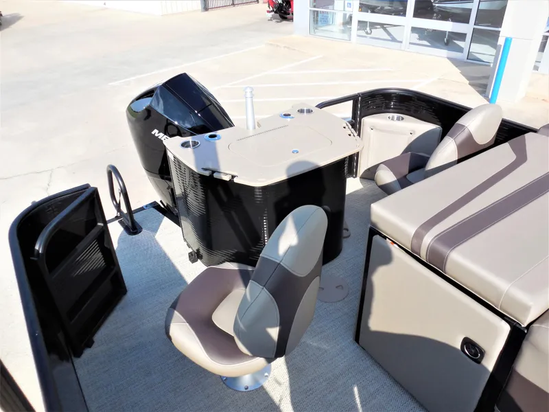 Slide: The Image of 2024 Bennington 23 SXF-APG boat interior with seating and Mercury outboard motor. - 7