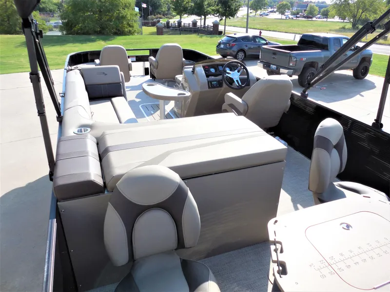 Slide: The Image of 2024 Bennington 23 SXF-APG pontoon boat interior with seating and steering console. - 8