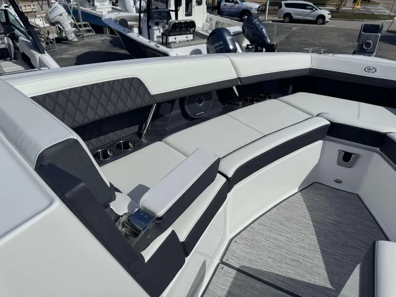 Slide: The Image of 2024 Cobalt R33 boat interior with cushioned seating and cup holders. - 10