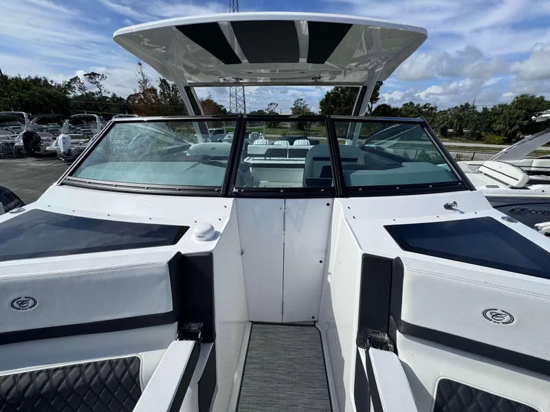 Slide: The Image of 2024 Cobalt R33 boat interior with windshield and seating area. - 12