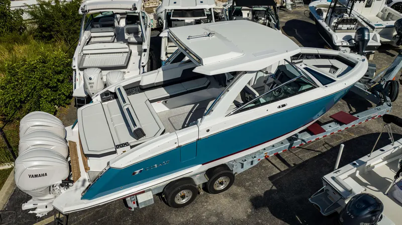 Slide: The Image of 2024 Cobalt R33 boat with triple Yamaha engines on trailer. - 13