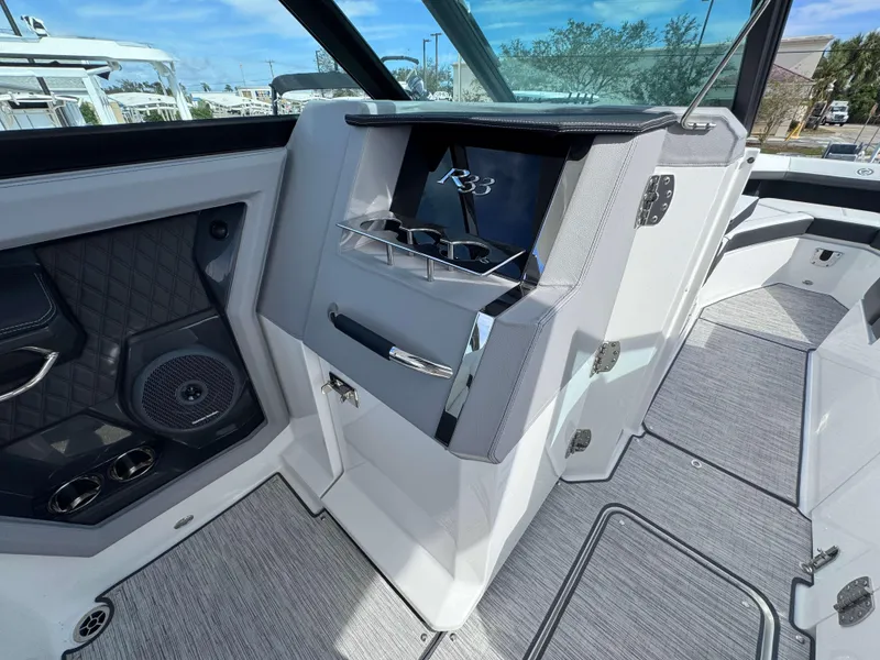 Slide: The Image of 2024 Cobalt R33 boat interior with modern dashboard and speaker system. - 15