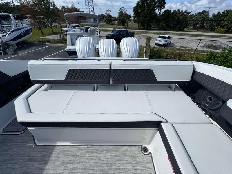 Slide: The Image of 2024 Cobalt R33 boat with luxurious seating and powerful outboard engines. - 19