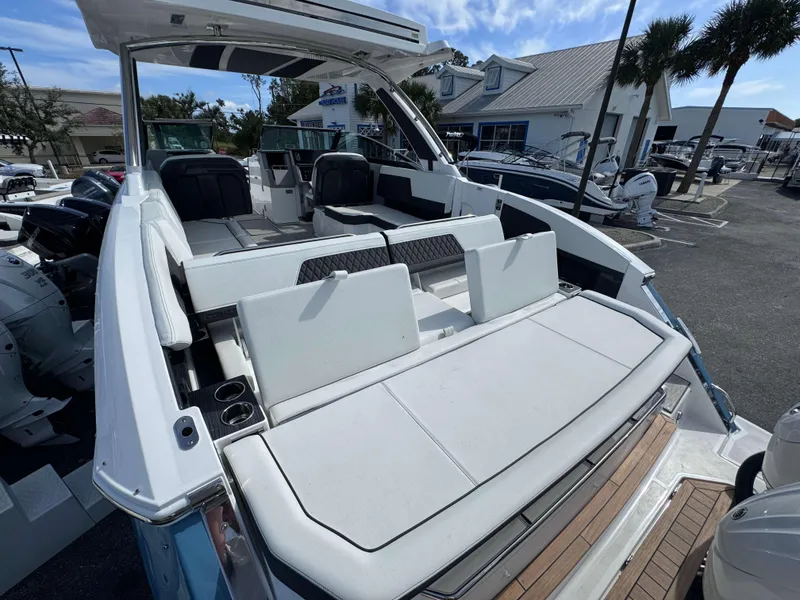 Slide: The Image of 2024 Cobalt R33 boat with spacious seating and modern design at a marina. - 21