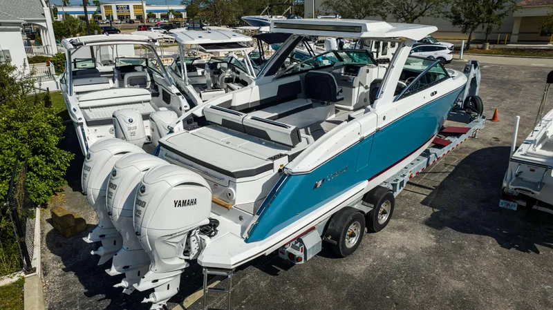 Slide: The Image of 2024 Cobalt R33 boat with triple Yamaha 300 V6 engines on a trailer. - 29