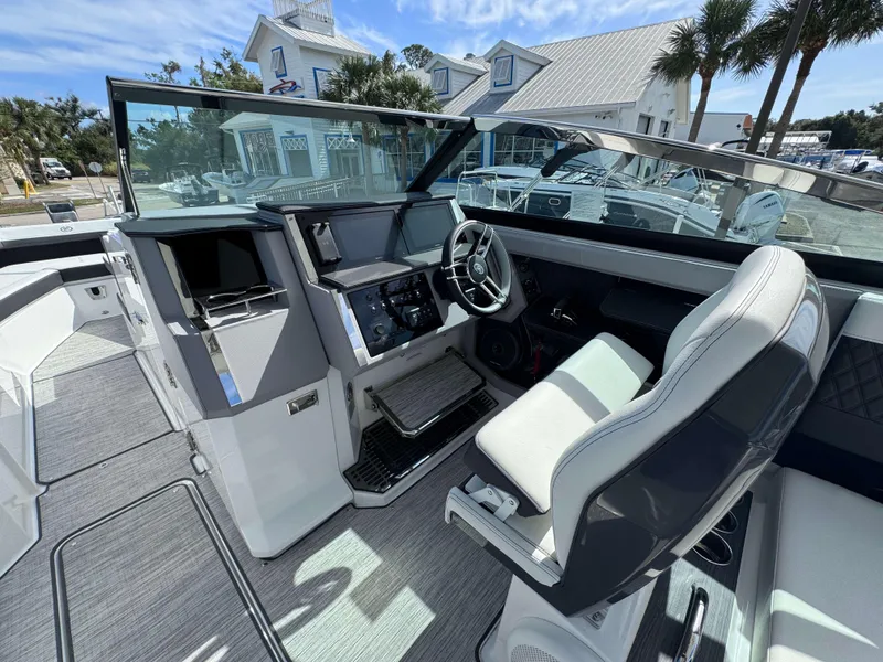 Slide: The Image of 2024 Cobalt R33 boat cockpit with modern dashboard and comfortable seating. - 7