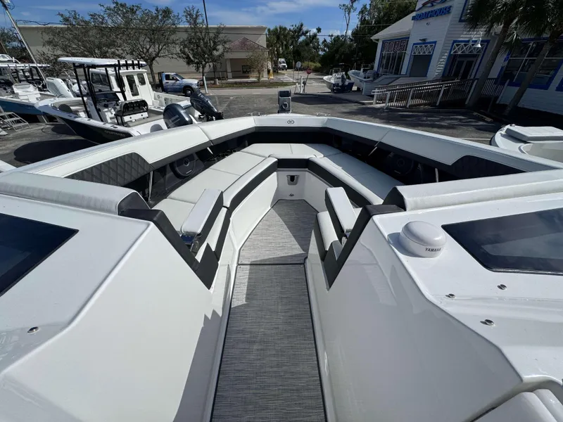Slide: The Image of 2024 Cobalt R33 boat interior with seating and Yamaha equipment at a marina. - 8